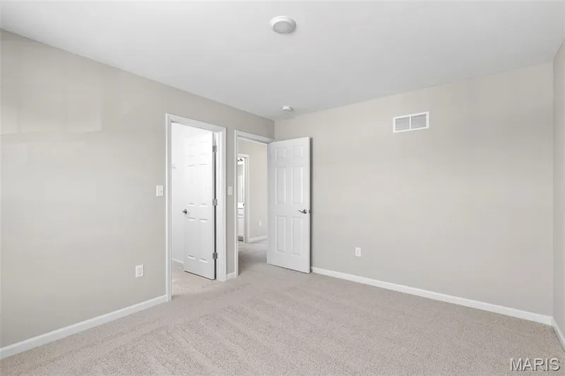 Unfurnished bedroom featuring light colored carpet and baseboards — 2 Hermitage II at Harvest Estate, O'Fallon, MO 63368