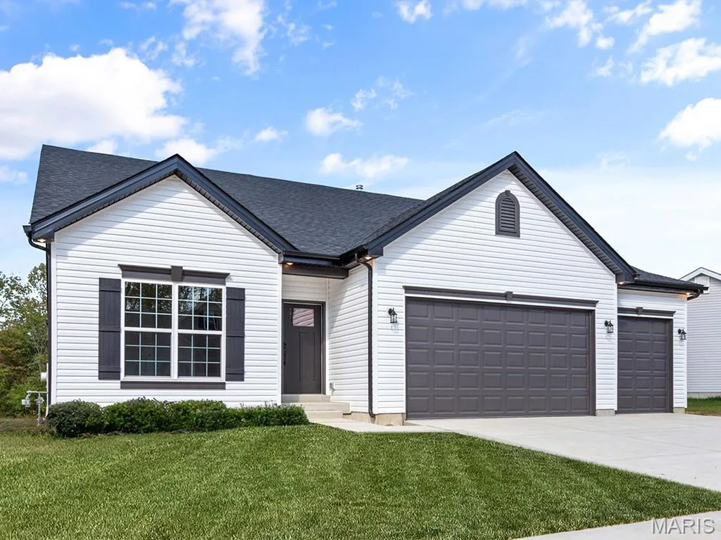 View of front of home featuring a garage, a front lawn, concrete driveway, and roof with shingles — 2 Maple Expanded at Harvest Est, O'Fallon, MO 63385