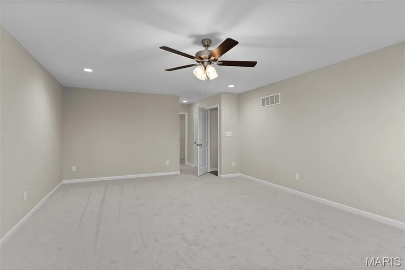 Empty room featuring ceiling fan, recessed lighting, light carpet, and baseboards — 2 Maple Expanded at Harvest Est, O'Fallon, MO 63385