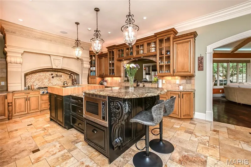 The next 5 photos are of the kitchen. The archway to the right leads to the Hearth Room — 4 Slate River Way, Wentzville, MO 63385