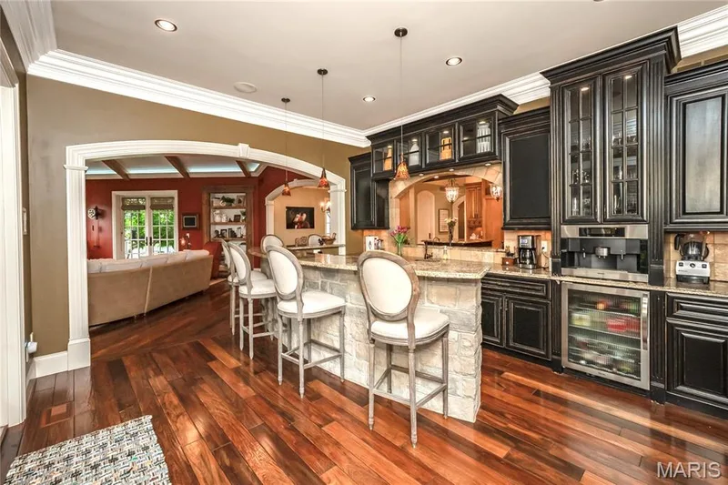 Custom cabinetry, open pass to the kitchen, built in frig, & wet sink are just some of the features of this versatile room — 4 Slate River Way, Wentzville, MO 63385