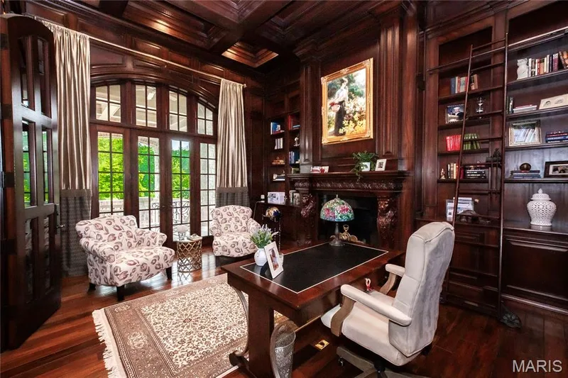 The custom wood work in the Library is exceptional: coffered ceiling, shelving, library ladder and hidden cubbyholes. The French doors lead to a covered porch & the fireplace is gas. — 4 Slate River Way, Wentzville, MO 63385