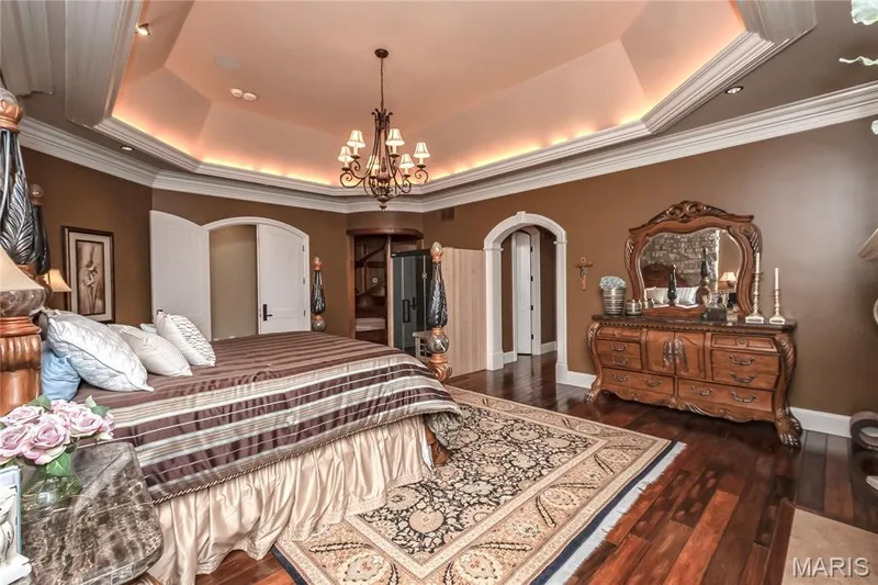 Hidden from view in this photo is a television which drops down from the ceiling (the location is over the doorway to the master bath en-suite — 4 Slate River Way, Wentzville, MO 63385