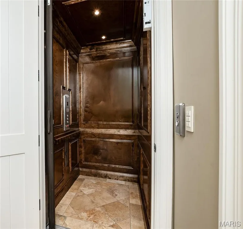 The elevator serves all three levels and must be seen in person to appreciate the millwork interior — 4 Slate River Way, Wentzville, MO 63385