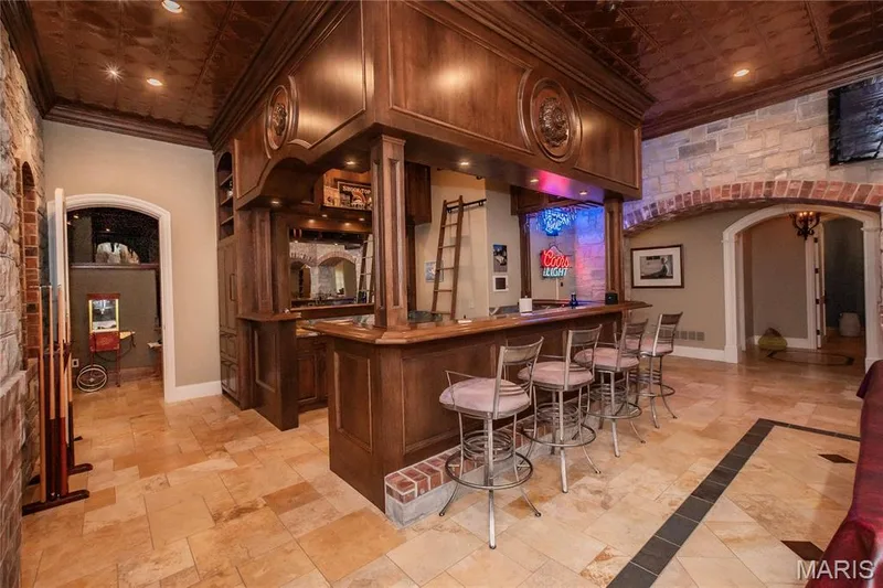 In this view of the bar, the doorway on the left is one of two entries into the Theater — 4 Slate River Way, Wentzville, MO 63385