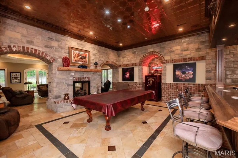 In this view you get a glimpse of the family room sitting on the other side of the see-thru gas fireplace — 4 Slate River Way, Wentzville, MO 63385