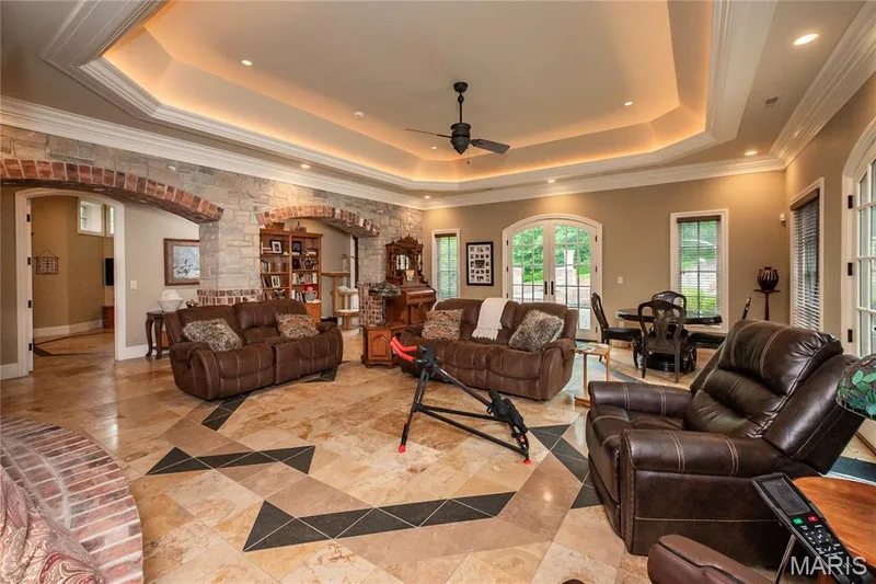 In this view of the family room you will notice the French doors which lead out to a patio near the fire pit & waterfalls — 4 Slate River Way, Wentzville, MO 63385