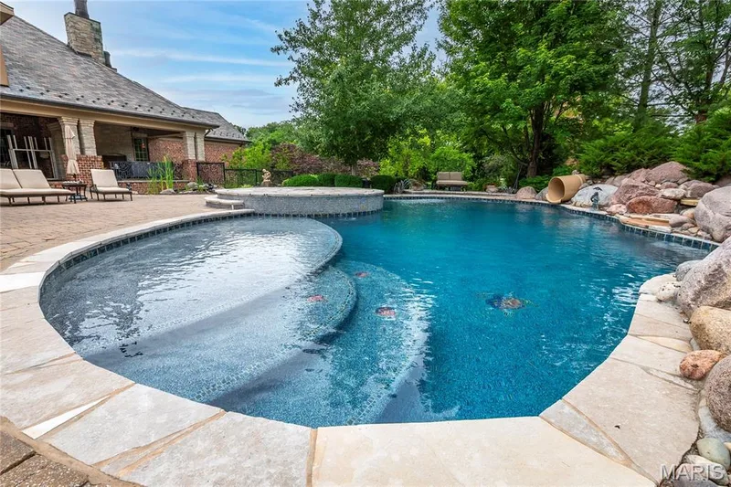 Now for some day and evening photos of the pool & patio area — 4 Slate River Way, Wentzville, MO 63385
