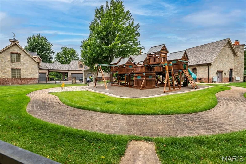 This children's playground sits behind the pool house & just off the courtyard. There is a 1/2 bath on this side of the pool house too & they sport new metal roofs — 4 Slate River Way, Wentzville, MO 63385