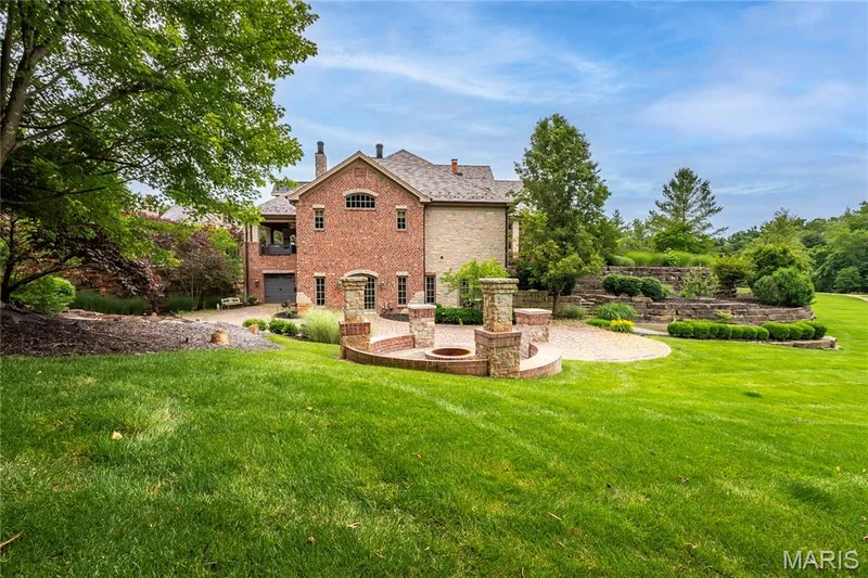 Pictured here is the patio off the LL Family room & Guest bedroom suite. Adjacent to the patio is a fire pit and 3 waterfalls — 4 Slate River Way, Wentzville, MO 63385