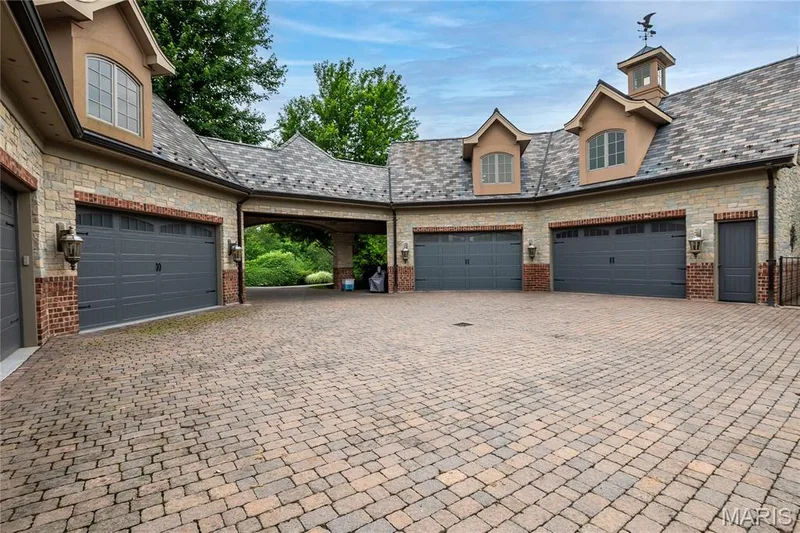 Two oversized 4 car garages, 1 attached & 1 detached. There is a beautiful apartment above one and above the other is a game room w/a second theater — 4 Slate River Way, Wentzville, MO 63385