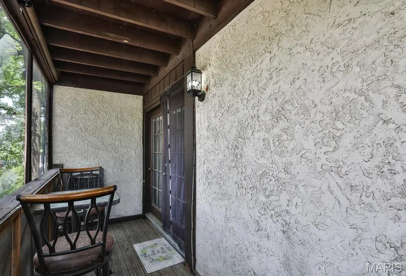 Doorway to property featuring stucco siding and french doors — 1380 Heritage Landing #206, St Charles, MO 63303