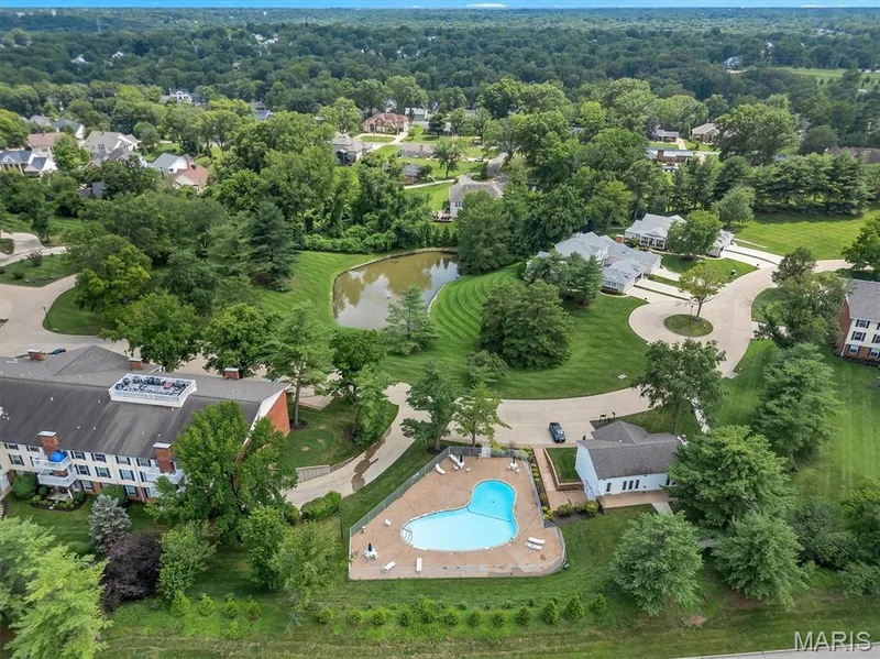 Aerial view of property's location featuring a nearby body of water and a pool — 1511 Hampton Hall Drive #19 & 20, Chesterfield, MO 63017