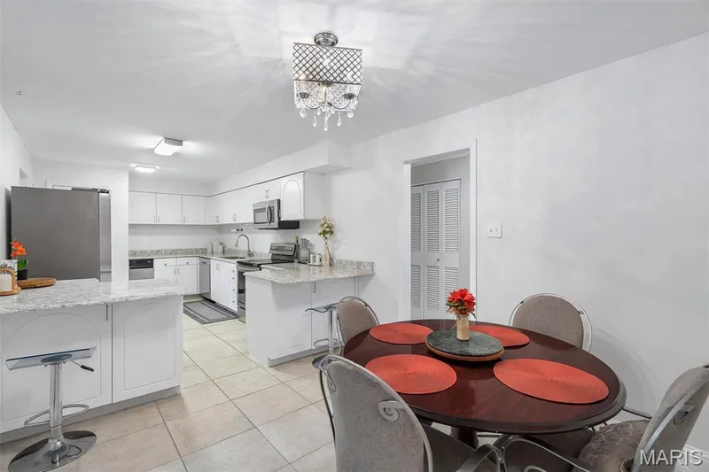 Dining room featuring light tile patterned floors and a chandelier — 1511 Hampton Hall Drive #19 & 20, Chesterfield, MO 63017