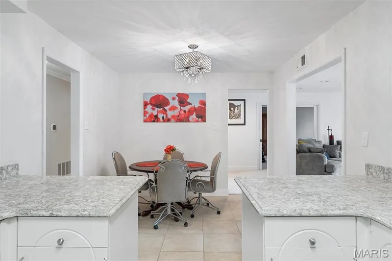 Dining area with a chandelier and light tile patterned flooring — 1511 Hampton Hall Drive #19 & 20, Chesterfield, MO 63017