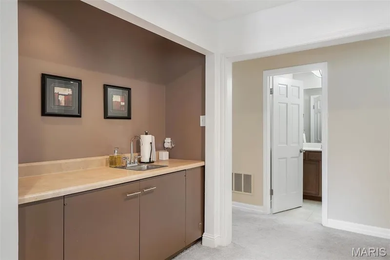 Indoor wet bar with light carpet and baseboards — 1511 Hampton Hall Drive #19 & 20, Chesterfield, MO 63017