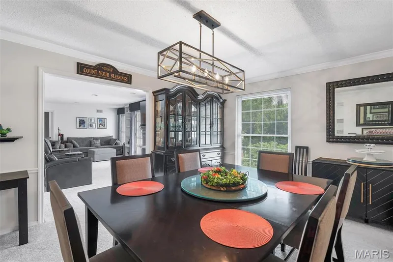 Dining area featuring a textured ceiling, carpet flooring, crown molding, and a chandelier — 1511 Hampton Hall Drive #19 & 20, Chesterfield, MO 63017