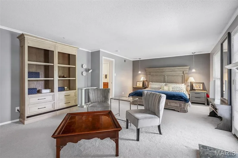 Primary Bedroom featuring crown molding, light colored carpet, and a textured ceiling — 1511 Hampton Hall Drive #19 & 20, Chesterfield, MO 63017