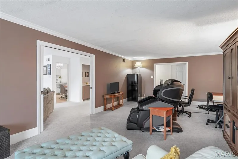 Living area with crown molding, light carpet, a textured ceiling, and a desk — 1511 Hampton Hall Drive #19 & 20, Chesterfield, MO 63017