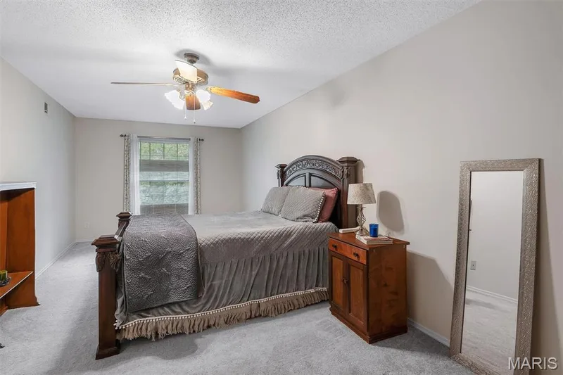Bedroom featuring light carpet, ceiling fan, and a textured ceiling — 1511 Hampton Hall Drive #19 & 20, Chesterfield, MO 63017