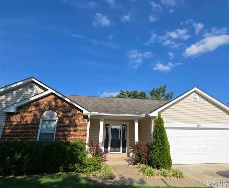 Ranch-style house featuring a garage, driveway, brick siding, a porch, and roof with shingles — 1218 Saddlemaker Drive, St Charles, MO 63304