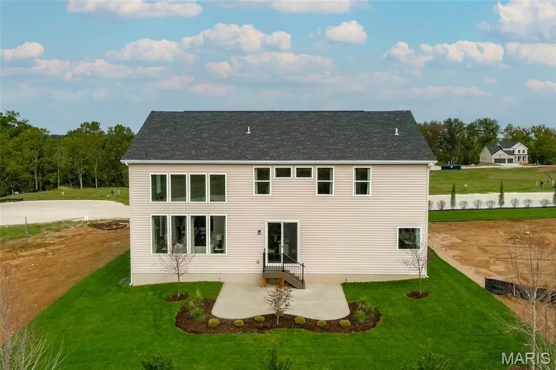 Back of house with a patio area, a yard, and roof with shingles — 0 Braxton @ Montage at Hawk Ridge, Lake St. Louis, MO 63367