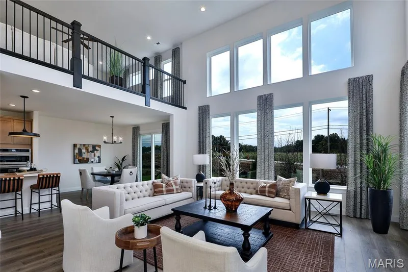 Living room featuring dark wood-type flooring, a towering ceiling, recessed lighting, and a chandelier — 0 Braxton @ Montage at Hawk Ridge, Lake St. Louis, MO 63367