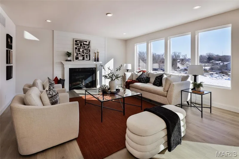 Living room featuring a glass covered fireplace, recessed lighting, and light wood-type flooring — 0 Bridgeport - Montage at Hawk Ridge, Lake St. Louis, MO 63367