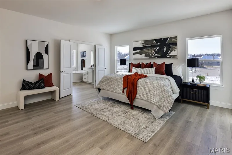 Bedroom featuring light wood-type flooring and ensuite bath — 0 Bridgeport - Montage at Hawk Ridge, Lake St. Louis, MO 63367