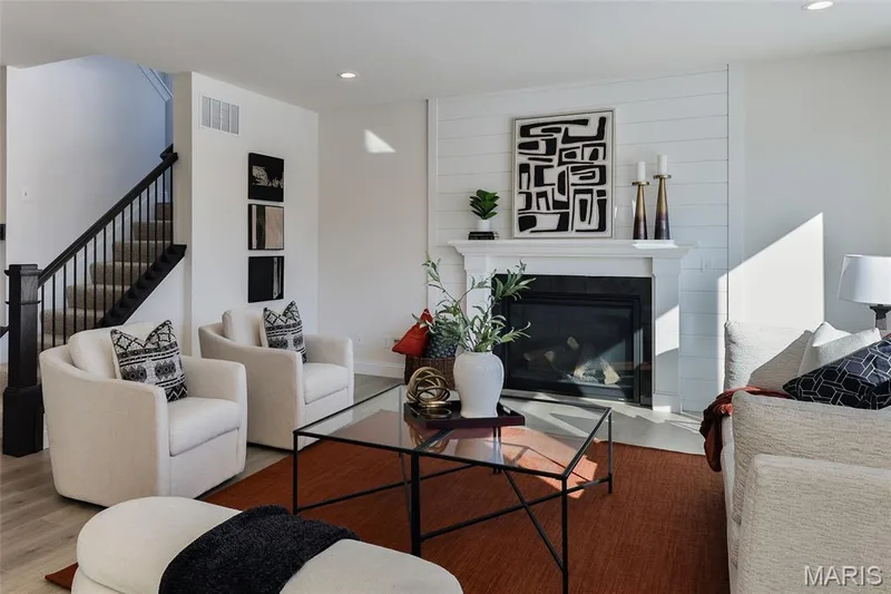 Living room with wood finished floors, recessed lighting, a fireplace, and stairs — 0 Bridgeport - Montage at Hawk Ridge, Lake St. Louis, MO 63367
