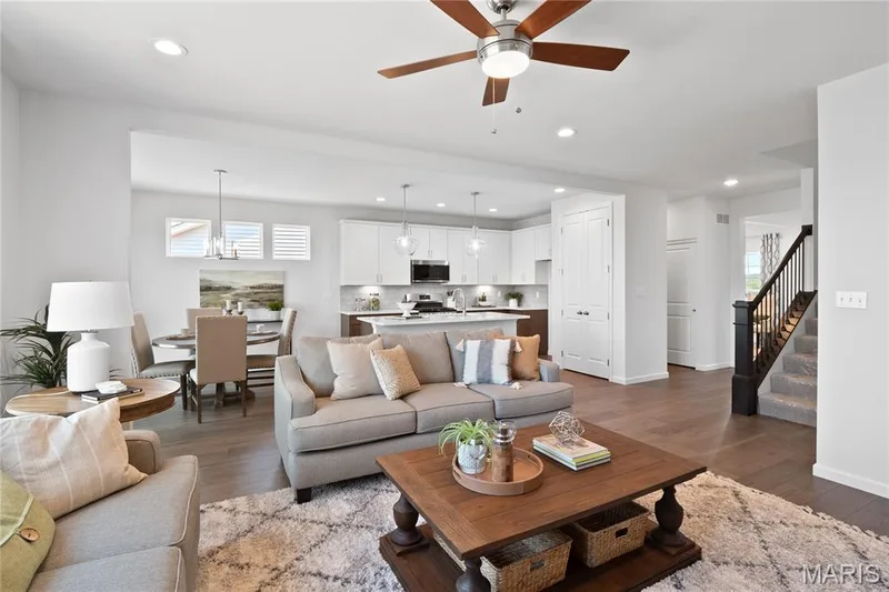 Living room featuring stairs, healthy amount of natural light, recessed lighting, dark wood finished floors, and ceiling fan — 0 Chesapeake @ Montage at Hawk Ridge, Lake St. Louis, MO 63367