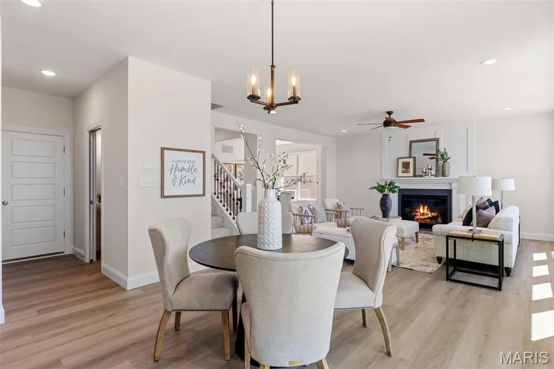 Dining room with recessed lighting, a glass covered fireplace, light wood finished floors, stairway, and a ceiling fan — 0 Lancaster @ Montage at Hawk Ridge, Lake St. Louis, MO 63367