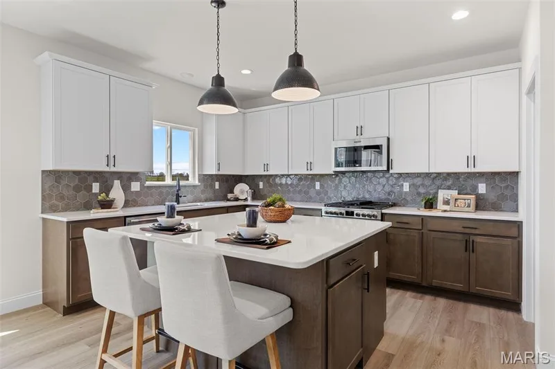 Kitchen featuring tasteful backsplash, a kitchen breakfast bar, a center island, pendant lighting, and recessed lighting — 0 Lancaster @ Montage at Hawk Ridge, Lake St. Louis, MO 63367
