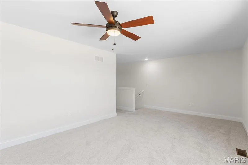 Unfurnished room with light colored carpet and ceiling fan — 0 Lancaster @ Montage at Hawk Ridge, Lake St. Louis, MO 63367