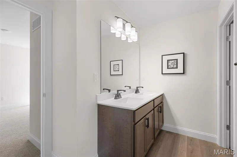 Bathroom featuring double vanity and light wood finished floors — 0 Lancaster @ Montage at Hawk Ridge, Lake St. Louis, MO 63367
