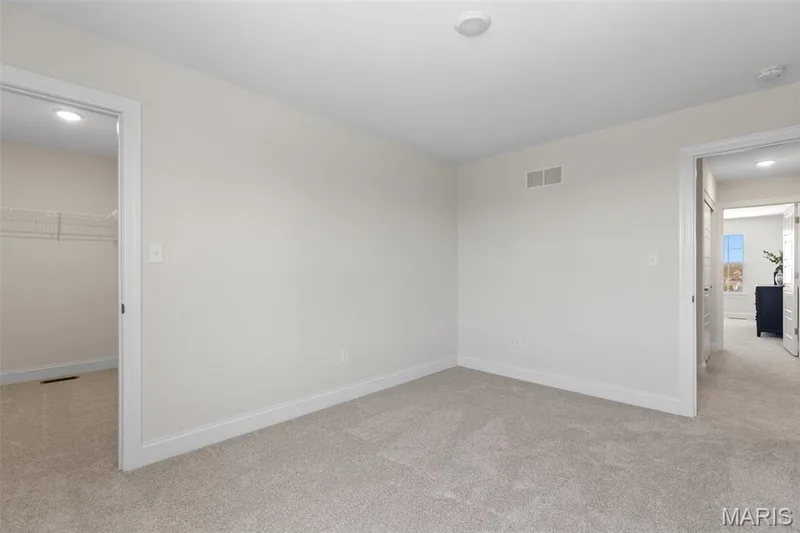 Unfurnished bedroom with light carpet, recessed lighting, and a spacious closet — 0 Lancaster @ Montage at Hawk Ridge, Lake St. Louis, MO 63367