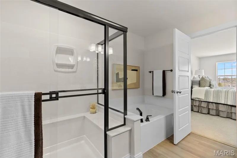 Ensuite bathroom featuring a stall shower, light wood-style flooring, and a garden tub — 0 Lancaster @ Montage at Hawk Ridge, Lake St. Louis, MO 63367