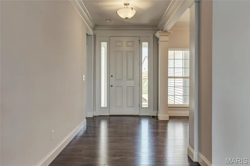 Foyer featuring ornamental molding, ornate columns, and dark wood finished floors — 0 Pierce @ Montage at Hawk Ridge, Lake St. Louis, MO 63367