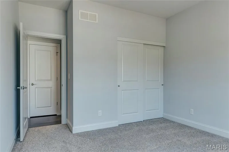 Unfurnished bedroom with light colored carpet and a closet — 0 Pierce @ Montage at Hawk Ridge, Lake St. Louis, MO 63367