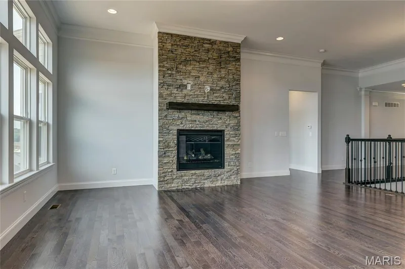 Unfurnished living room featuring crown molding, dark wood-style floors, a fireplace, and recessed lighting — 0 Pierce @ Montage at Hawk Ridge, Lake St. Louis, MO 63367