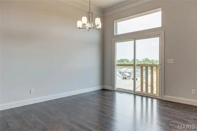 Empty room with crown molding, dark wood finished floors, a chandelier, and a high ceiling — 0 Pierce @ Montage at Hawk Ridge, Lake St. Louis, MO 63367