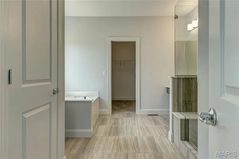 Bathroom with a spacious closet, a bath, and an enclosed shower — 0 Pierce @ Montage at Hawk Ridge, Lake St. Louis, MO 63367