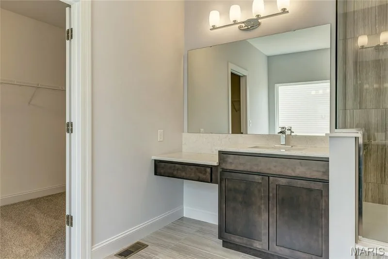 Bathroom with a walk in closet, vanity, and a tile shower — 0 Pierce @ Montage at Hawk Ridge, Lake St. Louis, MO 63367