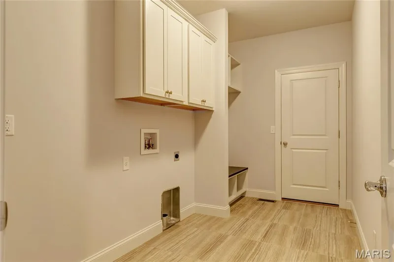 Washroom with hookup for an electric dryer, washer hookup, and cabinet space — 0 Pierce @ Montage at Hawk Ridge, Lake St. Louis, MO 63367