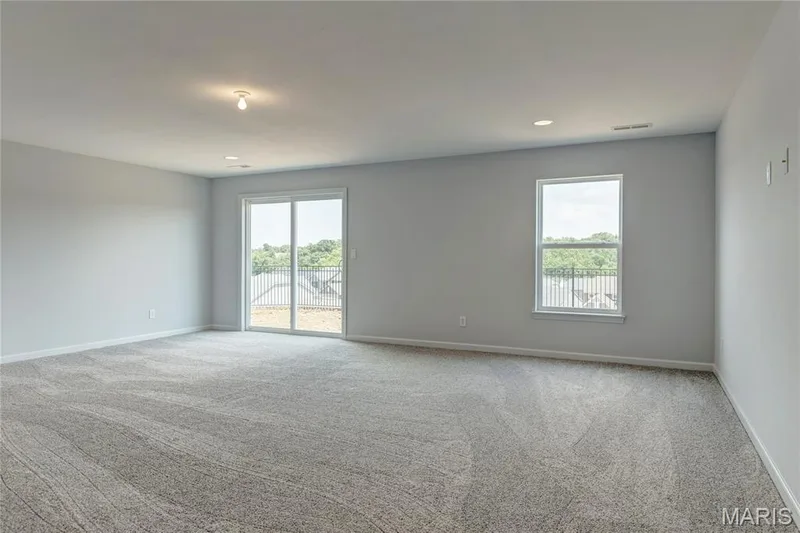 Unfurnished room with plenty of natural light, light colored carpet, and recessed lighting — 0 Pierce @ Montage at Hawk Ridge, Lake St. Louis, MO 63367