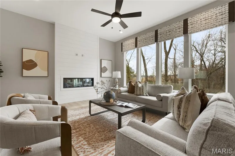 Living area with a large fireplace, wood finished floors, and ceiling fan — 0 Sierra @ Montage at Hawk Ridge, Lake St. Louis, MO 63367