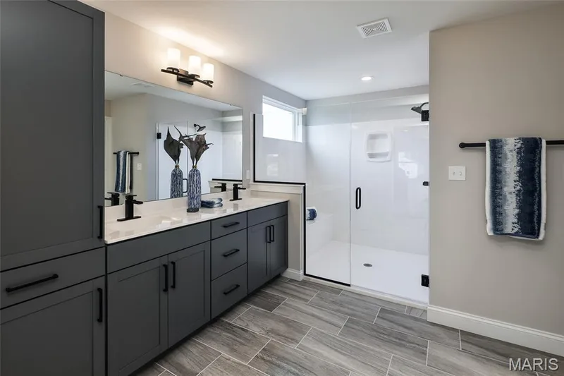 Bathroom featuring double vanity, a shower stall, wood tiled floors, and recessed lighting — 0 Windsor @ Montage at Hawk Ridge, Lake St. Louis, MO 63367