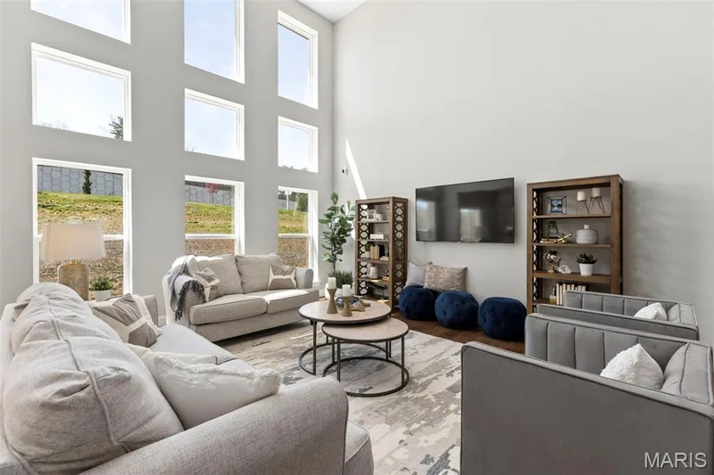Living room with wood finished floors and a high ceiling — 2 Pin Oak at Hawk Ridge Estate, Lake St. Louis, MO 63367