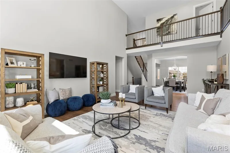 Living room with wood finished floors, a high ceiling, and a chandelier — 2 Pin Oak at Hawk Ridge Estate, Lake St. Louis, MO 63367