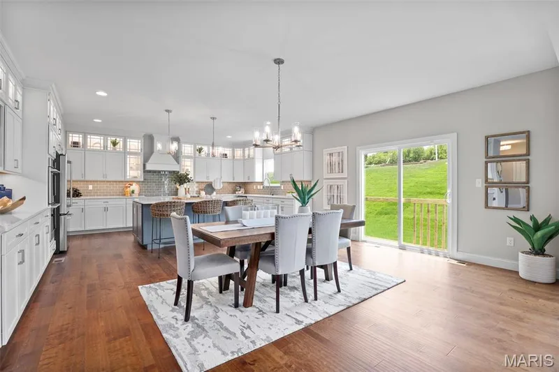 Dining room with a chandelier, dark wood-style floors, and recessed lighting — 2 Pin Oak at Hawk Ridge Estate, Lake St. Louis, MO 63367